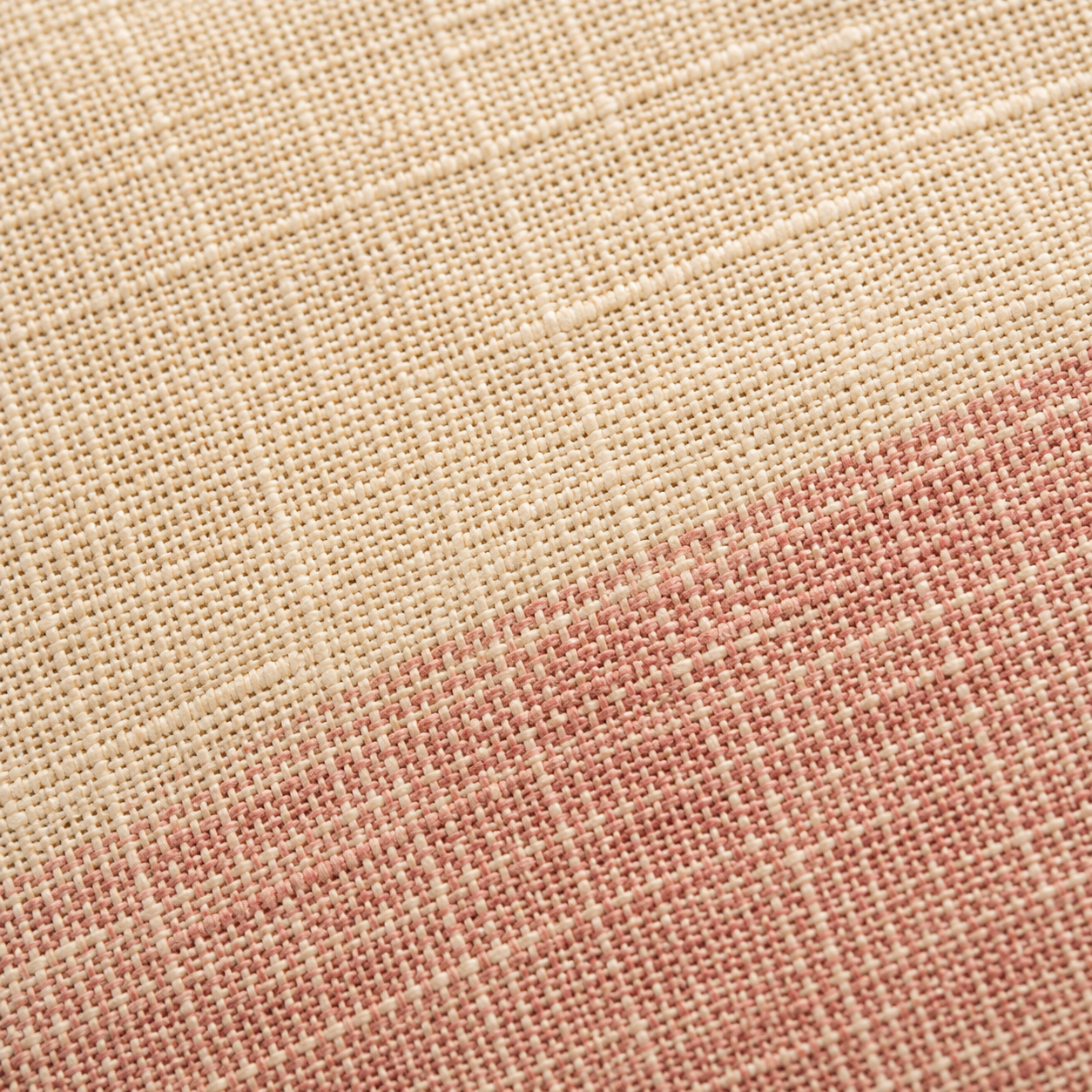 Macro detail of a handloom cotton weave showing the subtle thread irregularities of hand-loomed fabric