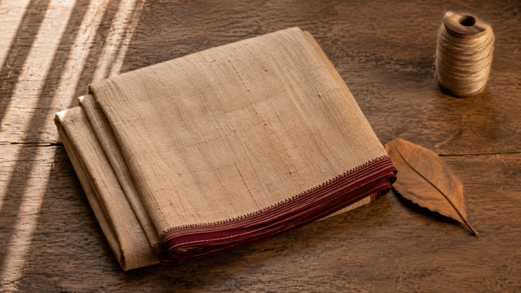 Tussar silk saree guide — a folded natural gold-beige tussar saree showing the wild silk slubby texture